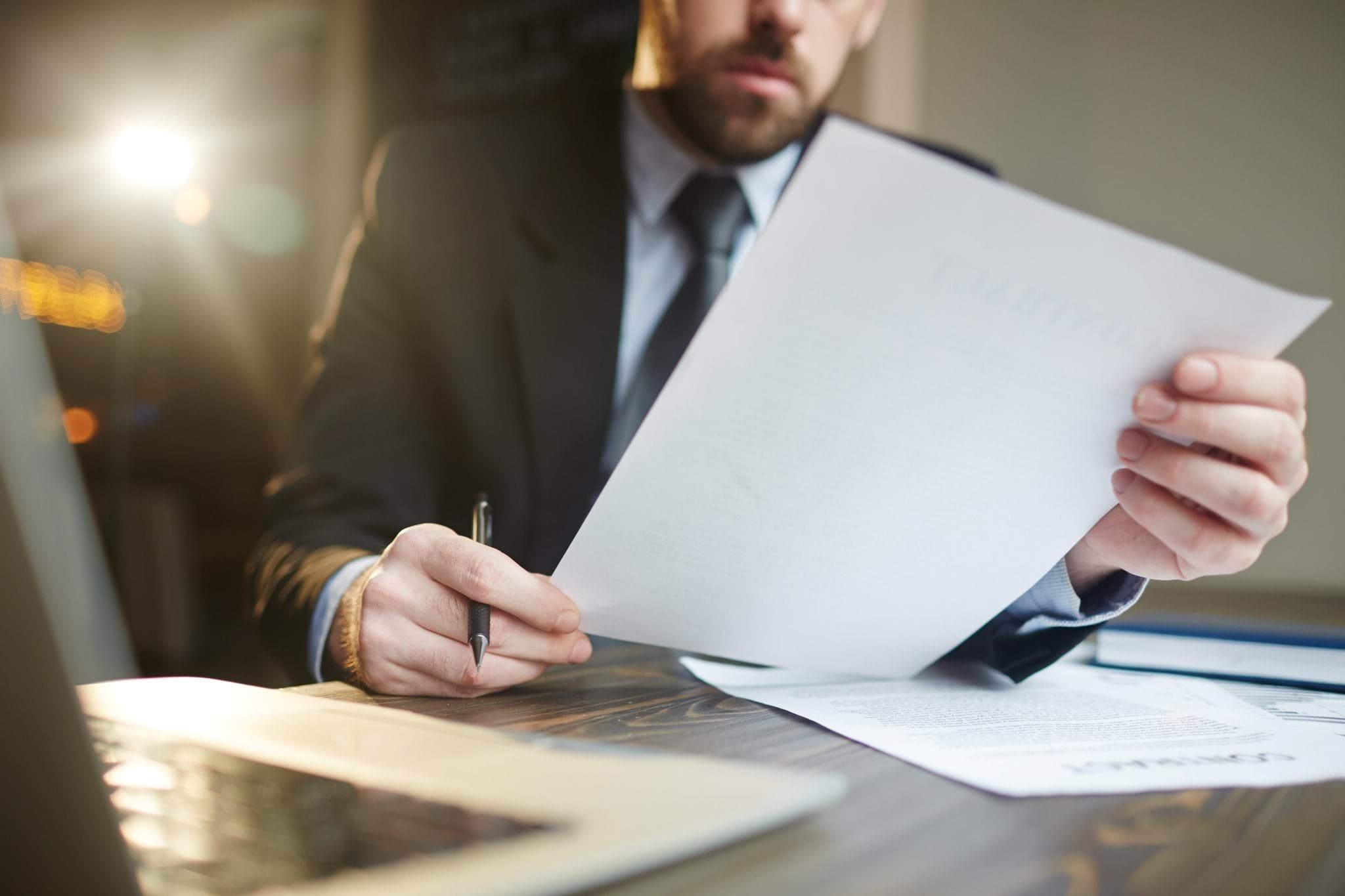 Man in suit looking at documents