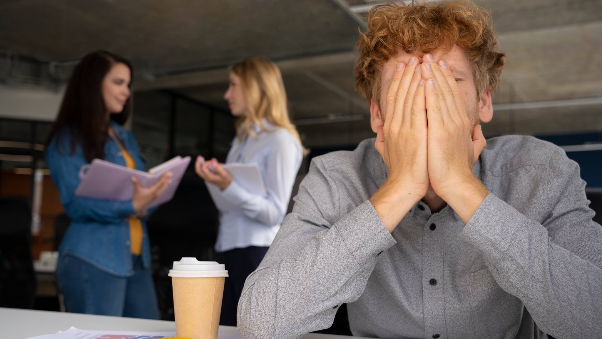 Young adult covering his face with both hands